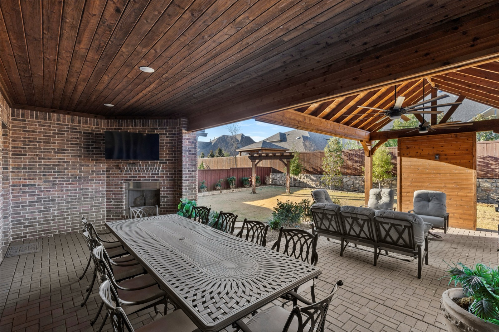 Covered patio with outdoor kitchen and fireplace